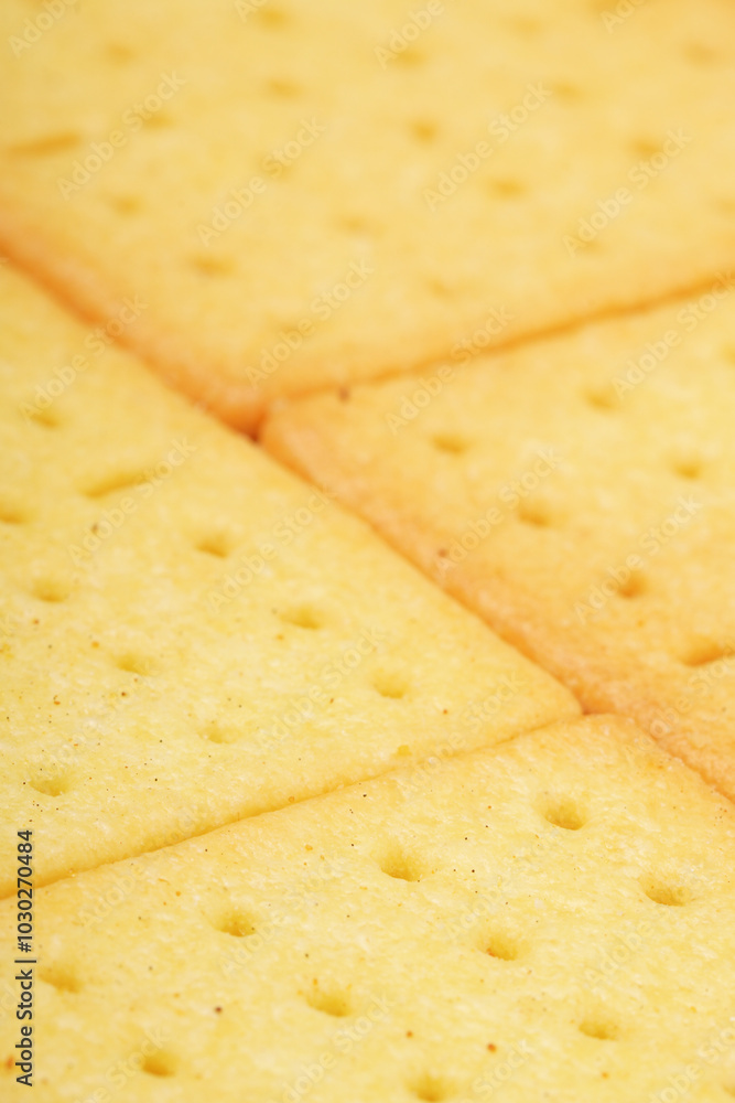 Rectangular, savory salty cheese-flavored biscuits with a golden-yellow color, neatly stacked. Perfect as a snack. Photographed on a white background. Rectangular, savory salty cheese-flavored biscuits with a golden-yellow color, neatly stacked. Perfect as a snack. Photographed on a white background.