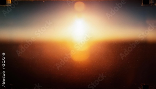 Warm Lens Flare through a smeared glas shot on 8mm Film with some film fragments grunge texture Bokeh