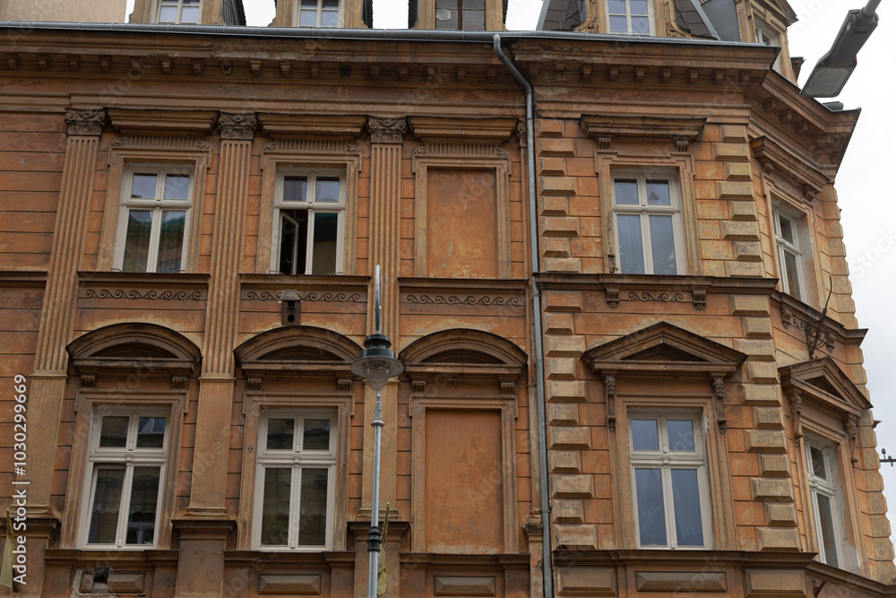 There is a large brick building that features numerous windows throughout its structure, creating a distinct architectural presence in the area There is a large brick building that features numerous windows throughout its structure, creating a distinct architectural presence in the area