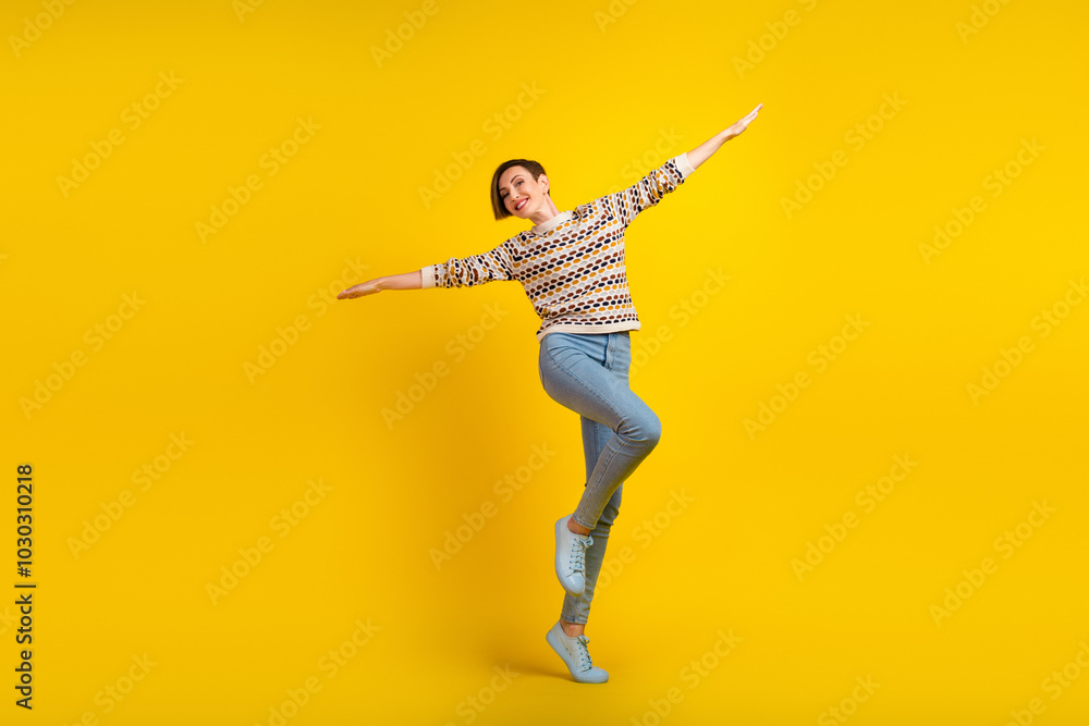 Full body photo of young girl jumping dressed stylish outfit isolated on yellow color background Full body photo of young girl jumping dressed stylish outfit isolated on yellow color background