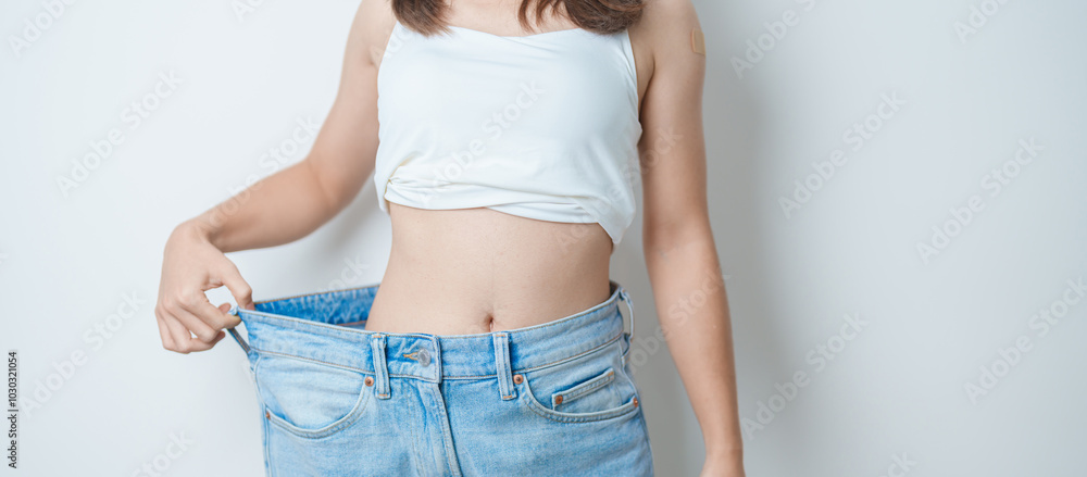 Εκτύπωση καμβά young slim female wearing big or oversize jeans, woman show healthy shape after weight loss