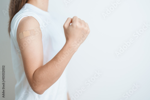 Woman with bandage after receiving vaccine. Vaccination and Immunization for Influenza, HPV, Zoster, IPD, DTP or Diphtheria, Tetanus and Pertussis, MMR, Hepatitis B, Covid  and Varicella vaccine photo