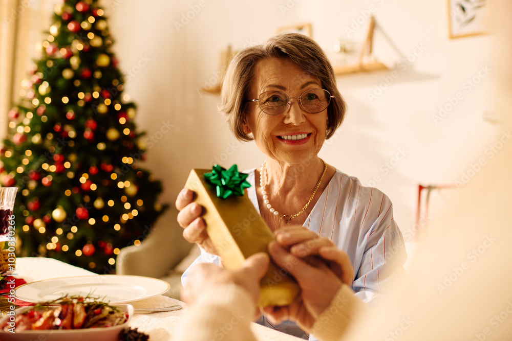 A happy senior couple enjoys a cozy Christmas celebration, exchanging gifts by the decorated tree. A happy senior couple enjoys a cozy Christmas celebration, exchanging gifts by the decorated tree.