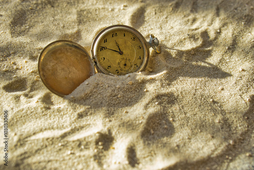 old pocket watch in the sand