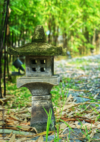 Single old stone lamp in the garden, Japanese stone lamp, vertical image Japanese stone lamp in the bamboo garden.