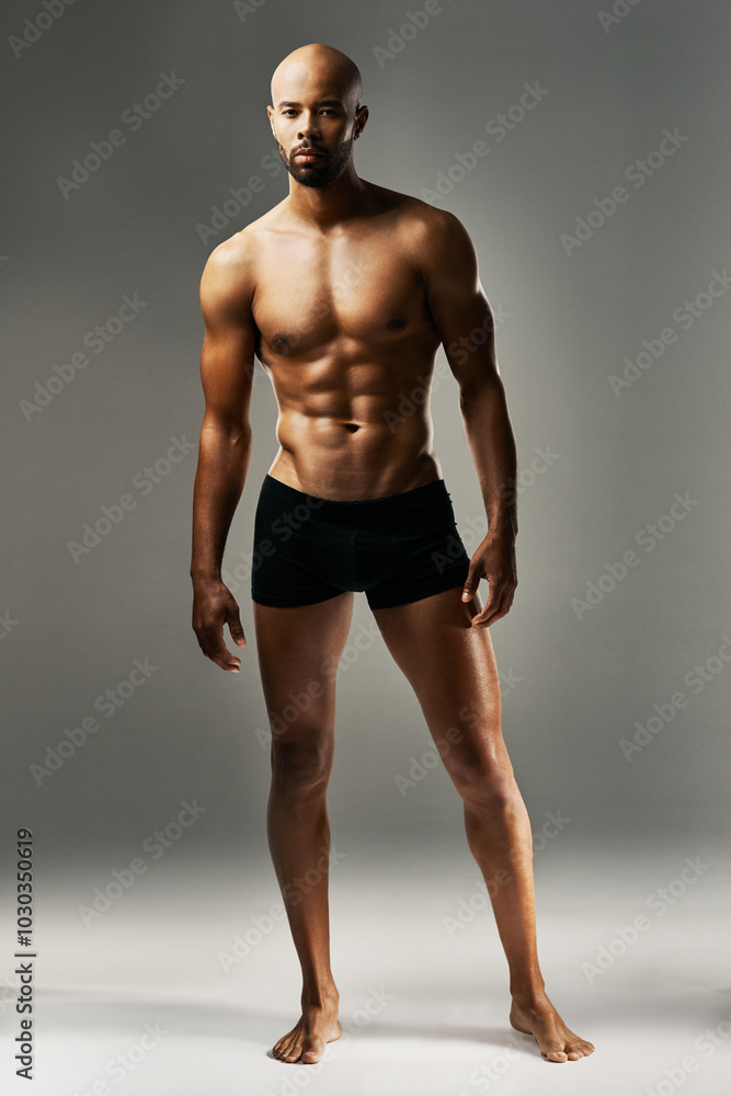 Studio, muscle and portrait of man with underwear, wellness and gym results for fitness aesthetic. Confident, proud bodybuilder or strong male model with healthy body development on grey background. Studio, muscle and portrait of man with underwear, wellness and gym results for fitness aesthetic. Confident, proud bodybuilder or strong male model with healthy body development on grey background.