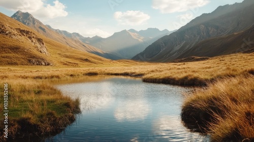 Fototapeta Naklejka Na Ścianę i Meble -  A peaceful mountain landscape featuring a calm body of water that reflects the clear blue sky and surrounding grassy hills under a soft golden light.