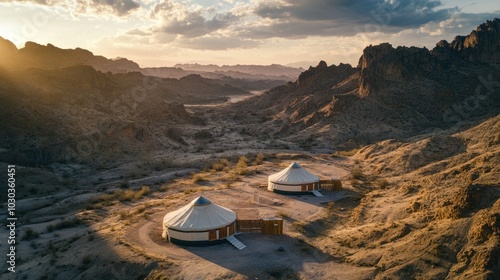 Yurts in Xinjiang Uygur Autonomous Region, set in the backdrop of dramatic desert landscapes and rugged terrain