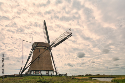 old windmill under cloudy sky