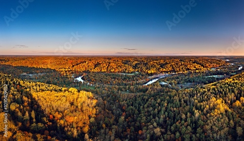 Obraz na płótnie Colorful sunrise over the Gauja National park valley. Sigulda city panorama from drone with forest in autumn colors. w salonie