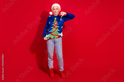 Full body portrait of pretty aged lady show thumb up down empty space new year xmas isolated on vibrant red color background