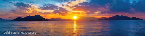 Panoramic colorful sunset over the sea with mountains.