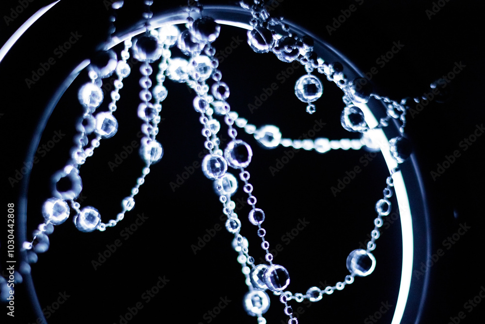 Crystal disco beads hanging garland shining on dark background. Christmas, New Year 2025 Crystal disco beads hanging garland shining on dark background. Christmas, New Year 2025