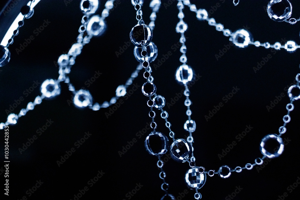 Crystal disco beads hanging garland shining on dark background. Christmas, New Year 2025 Crystal disco beads hanging garland shining on dark background. Christmas, New Year 2025