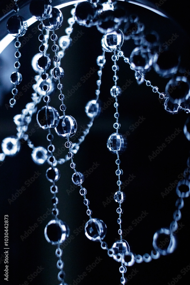Crystal disco beads hanging garland shining on dark background. Christmas, New Year 2025 Crystal disco beads hanging garland shining on dark background. Christmas, New Year 2025