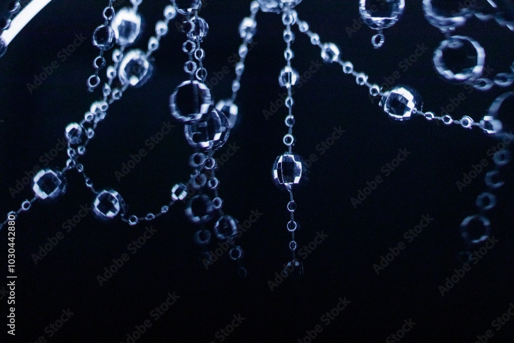 Crystal disco beads hanging garland shining on dark background. Christmas, New Year 2025 Crystal disco beads hanging garland shining on dark background. Christmas, New Year 2025