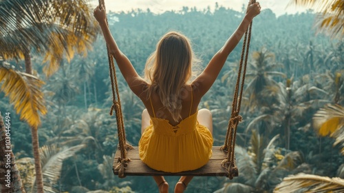 A woman sitting on a wooden swing in the jungle. photo