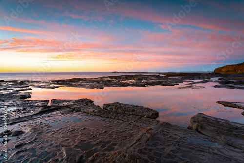 Sunrise, rock pools and textured rocks
