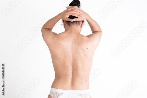 young woman, from behind, showing her back with scoliosis, pain, bad posture