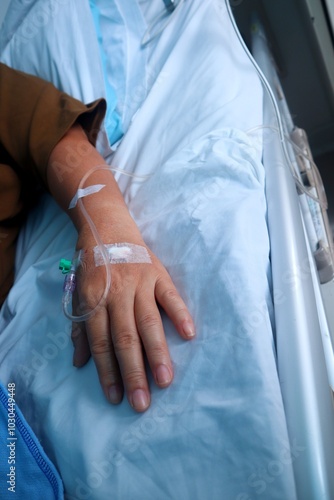 A female patient was lying limp in the hospital while her hand had been put on an IV.