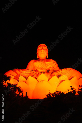 Glowing Orange Buddha Statue on Lotus Flower