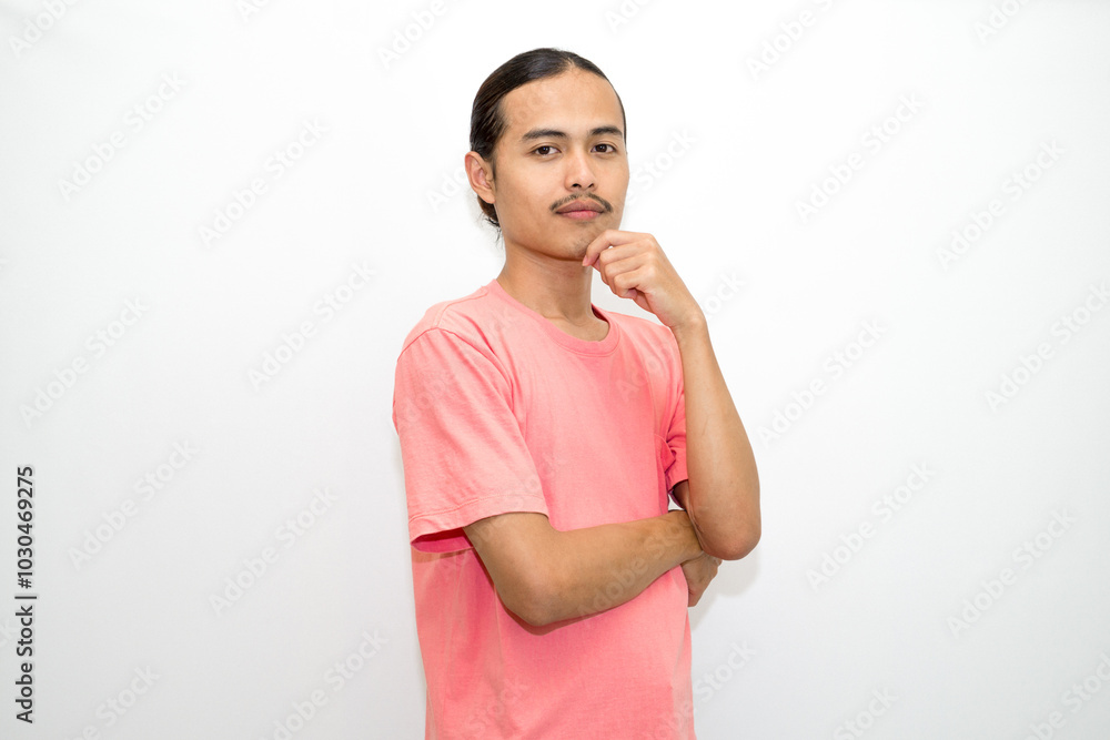 An Indonesian, Asian man wearing a pink tshirt formal style involving his partner with standing confidence like a mature person and a young businessman. isolated in white background An Indonesian, Asian man wearing a pink tshirt formal style involving his partner with standing confidence like a mature person and a young businessman. isolated in white background