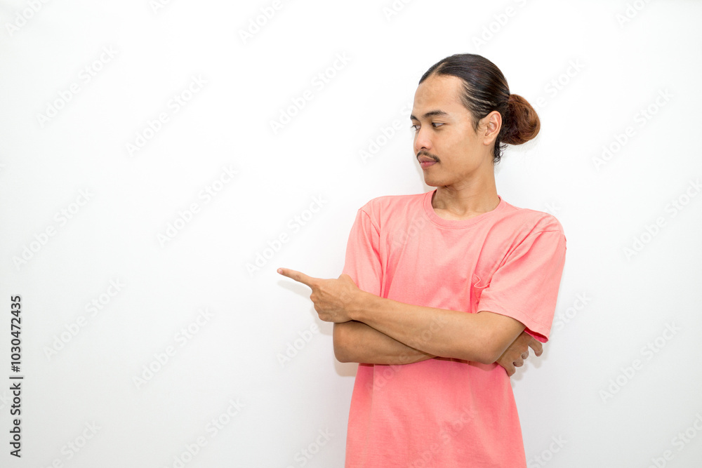 Asian, Indonesian man standing wearing pink shirt pointing right, left, up, down and presenting using hand gestures. Isolated on white background Asian, Indonesian man standing wearing pink shirt pointing right, left, up, down and presenting using hand gestures. Isolated on white background