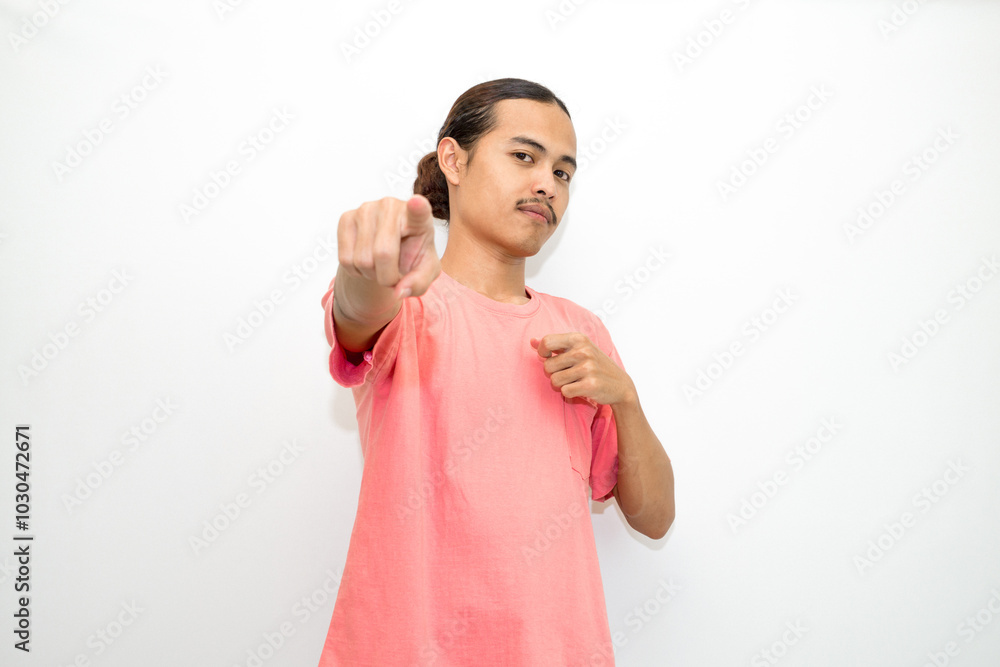 Asian, Indonesian man standing wearing pink shirt pointing right, left, up, down and presenting using hand gestures. Isolated on white background Asian, Indonesian man standing wearing pink shirt pointing right, left, up, down and presenting using hand gestures. Isolated on white background