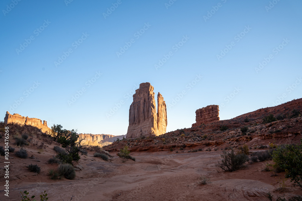 A low-angle view of the Courthouse Towers red rocks in Arches National Park. A low-angle view of the Courthouse Towers red rocks in Arches National Park.