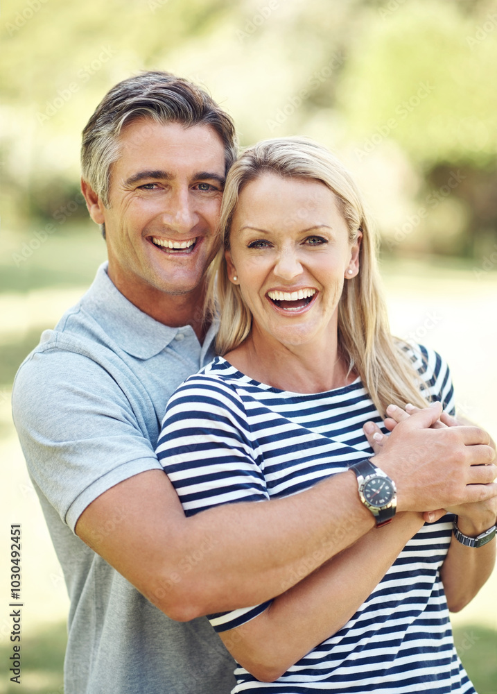 Fototapeta premium Smile, hug and portrait of couple in nature at park for bonding, marriage and connection in morning. Outdoor, happy and mature man and woman embracing in garden for romance on date with love together
