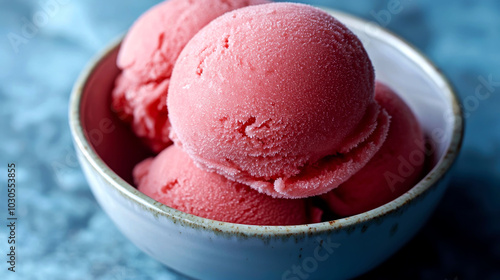 Bowl of pink ice cream scoops. photo