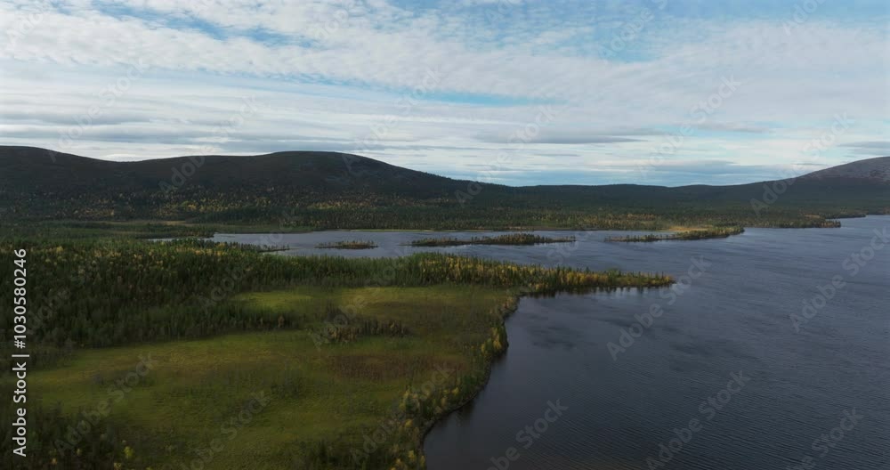 Aerial orbit above a lake with fells in the horizon Aerial orbit above a lake with fells in the horizon