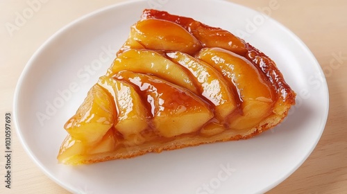 Wallpaper Mural A slice of delicious apple tart, featuring golden caramelized apple slices arranged on a flaky pastry crust, served on a white plate. Torontodigital.ca
