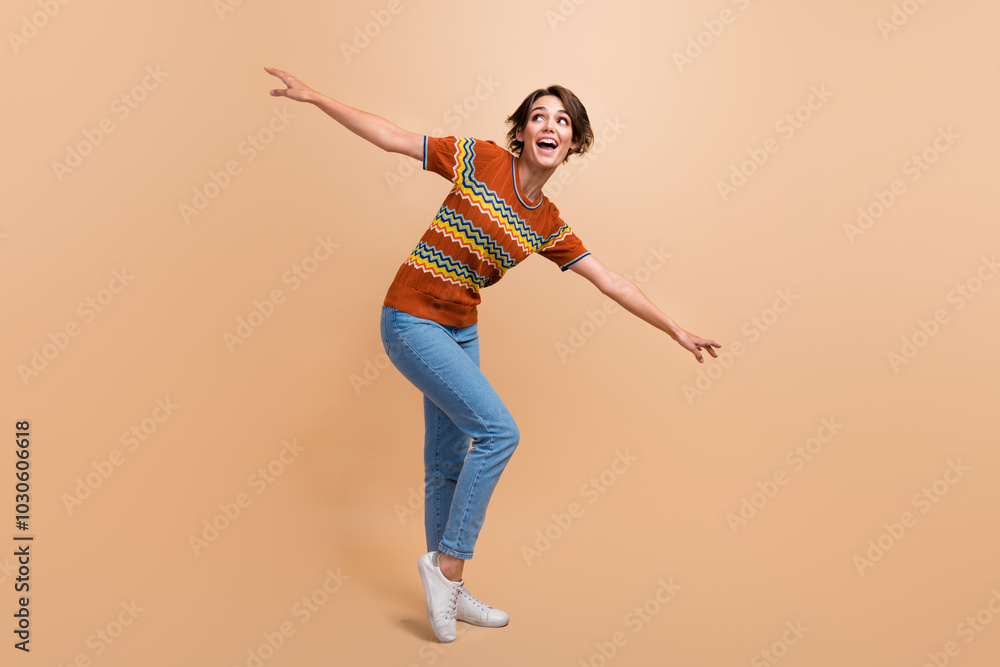 Full length photo of satisfied overjoyed person enjoy dancing partying free time isolated on beige color background Full length photo of satisfied overjoyed person enjoy dancing partying free time isolated on beige color background