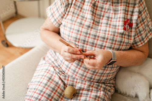 Hands of a senior woman crocheting captured in close-up