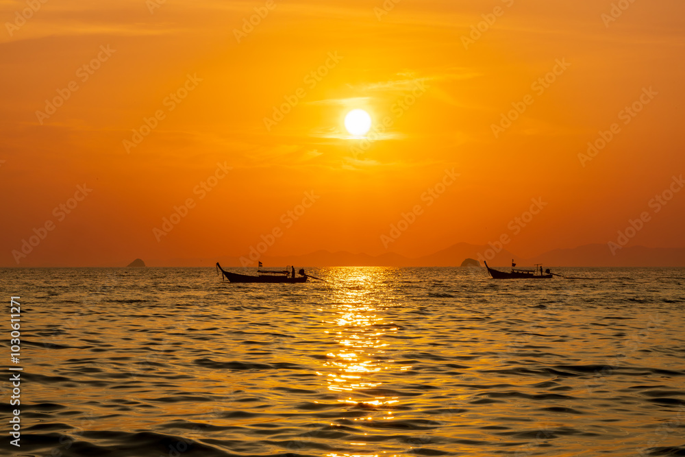 Longtail boat at sunset at Ao Nang Beach, Thailand Longtail boat at sunset at Ao Nang Beach, Thailand