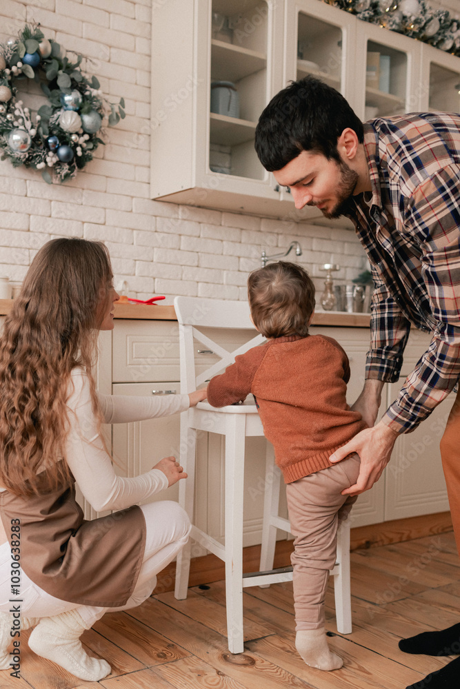 Fototapeta premium Happy moments in the family and time spent together with relatives on the eve of Christmas. Concept of gifts for New Year, Mother's Day and Father's Day. Modern kitchen interior. Part of a series