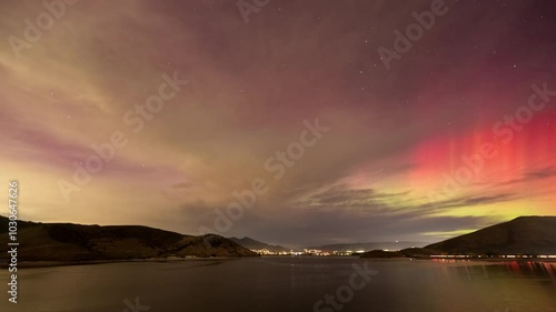 Timelapse of the Northern Lights over Deer Creek Reservoir in Utah as colorful aurora dances in the sky. photo