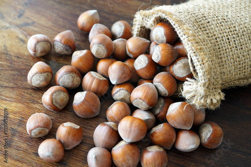 Hazelnuts in linen sack on wooden table