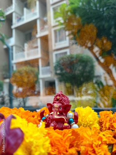 Lord Ganesha decorated with flowers beautiful red color ganpati bappa detailed sculpture, cute ganesha idol with flowers
