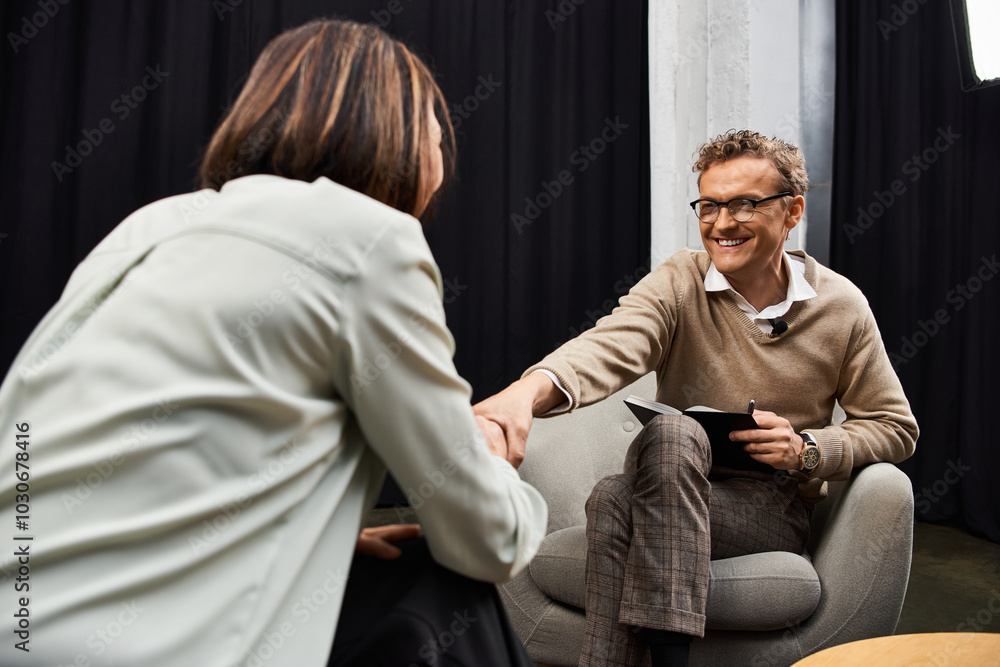 A journalist conducts an insightful interview with a specialist in a modern studio environment. A journalist conducts an insightful interview with a specialist in a modern studio environment.
