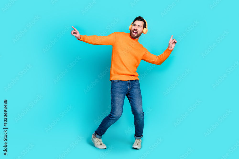 Photo of crazy positive man meloman wear trendy clothes dance music empty space isolated on cyan color background Photo of crazy positive man meloman wear trendy clothes dance music empty space isolated on cyan color background