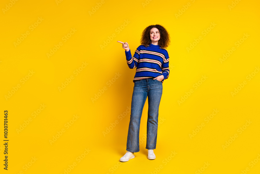 Full size photo of good mood girl with wavy hair wear knit pullover look directing at sale empty space isolated on yellow color background Full size photo of good mood girl with wavy hair wear knit pullover look directing at sale empty space isolated on yellow color background