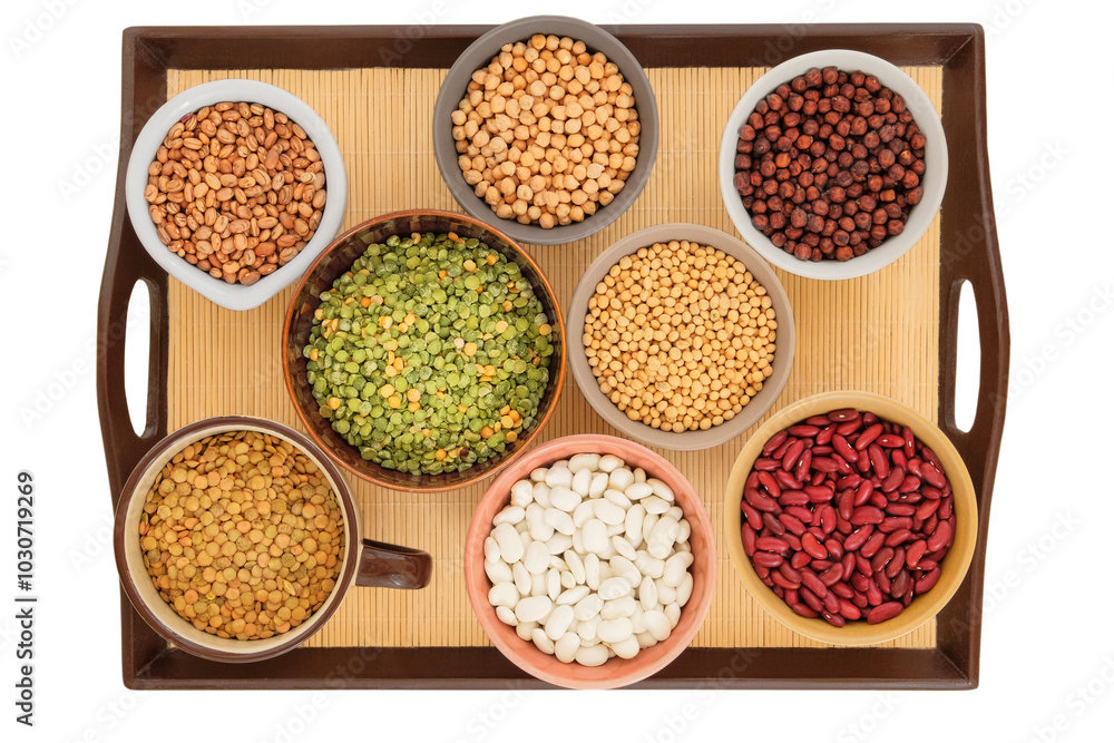 Variety of protein products for vegetarians. Soy, lentils, peas, chickpeas and various types of beans in bowls on a tray. Isolated on a white background. Variety of protein products for vegetarians. Soy, lentils, peas, chickpeas and various types of beans in bowls on a tray. Isolated on a white background.