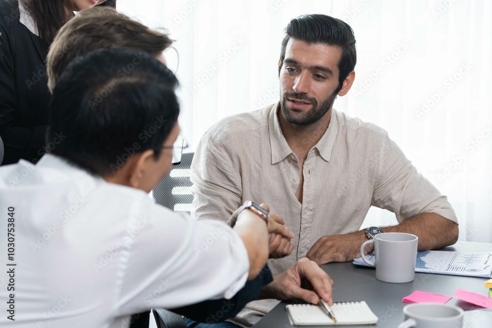 Fototapeta premium Diverse group of office employee worker shake hand after making agreement on strategic business marketing meeting. Teamwork and positive attitude create productive and supportive workplace. Prudent