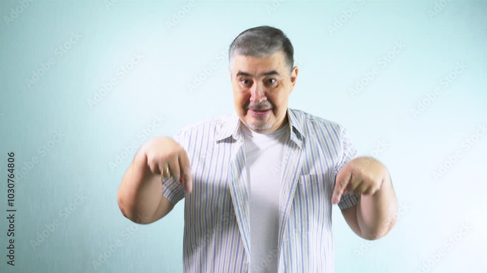 A man making hand gestures indicating 'Look Down!' Suitable for advertising. A man making hand gestures indicating 'Look Down!' Suitable for advertising.