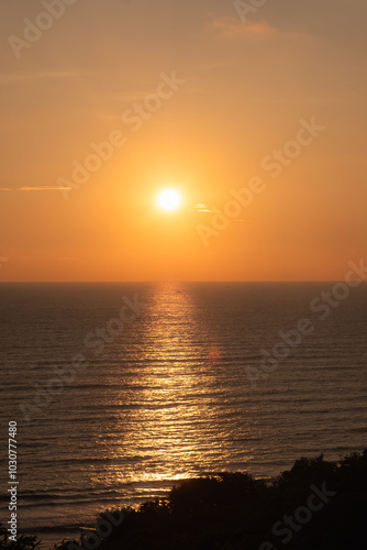 Beautiful red and orange sunrise over the sea. Beautiful seascape scenery, Man holding the hand of his wife