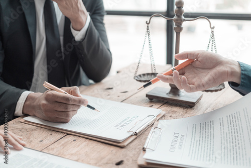 Male lawyer working with contract documents and wooden hammer on table in courtroom justice and law Judge in suit or lawyer working with documents Law, advice, close-up pictures