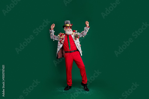 Full length photo of old cool man winning dance dressed decor balls baubles on jacket sunglass hat isolated on green color background