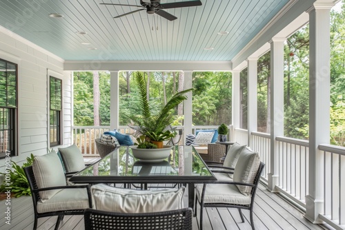 White Screened Porch with Light Blue Ceiling, Glass Table, and Coastal Style Black Metal Furniture